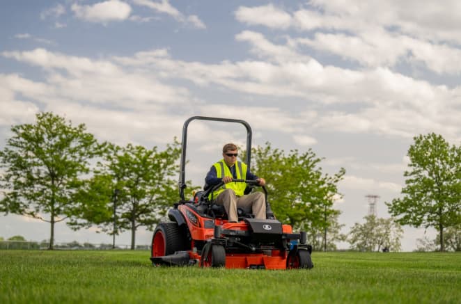 Kubota ZD1211 diesel zero-turn mower mowing an open lawn, for sale at Bobby Ford in Angleton